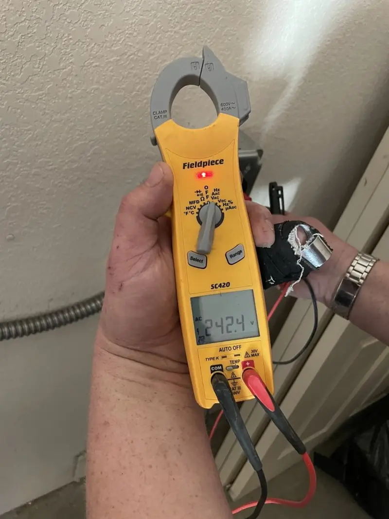 Voltage testing with clamp meter during Recessed Lighting Installation in Dansville